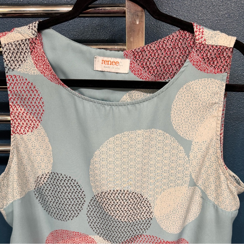 Renee C. Light Teal Top with green and rust color Accents